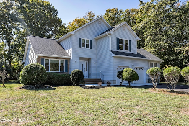 front of property with a front yard and a garage