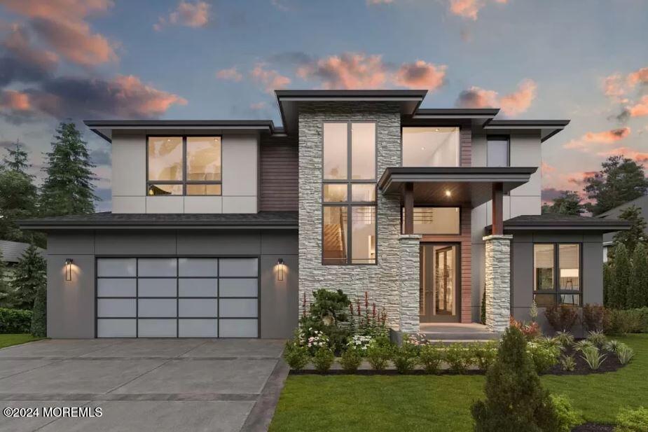 contemporary house featuring a yard and a garage