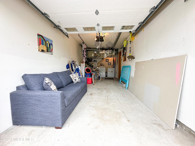 garage featuring washing machine and clothes dryer and a garage door opener