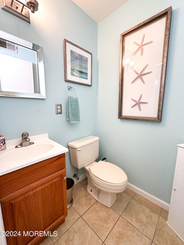 bathroom with vanity, tile patterned flooring, and toilet