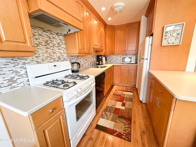 kitchen featuring custom exhaust hood, sink, white appliances, backsplash, and light hardwood / wood-style floors