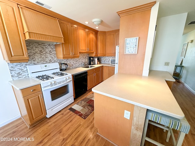 kitchen featuring light hardwood / wood-style floors, white range with gas stovetop, black dishwasher, kitchen peninsula, and premium range hood