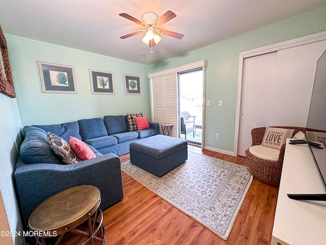 living room with ceiling fan and hardwood / wood-style flooring