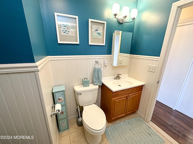 bathroom with wood-type flooring, vanity, and toilet