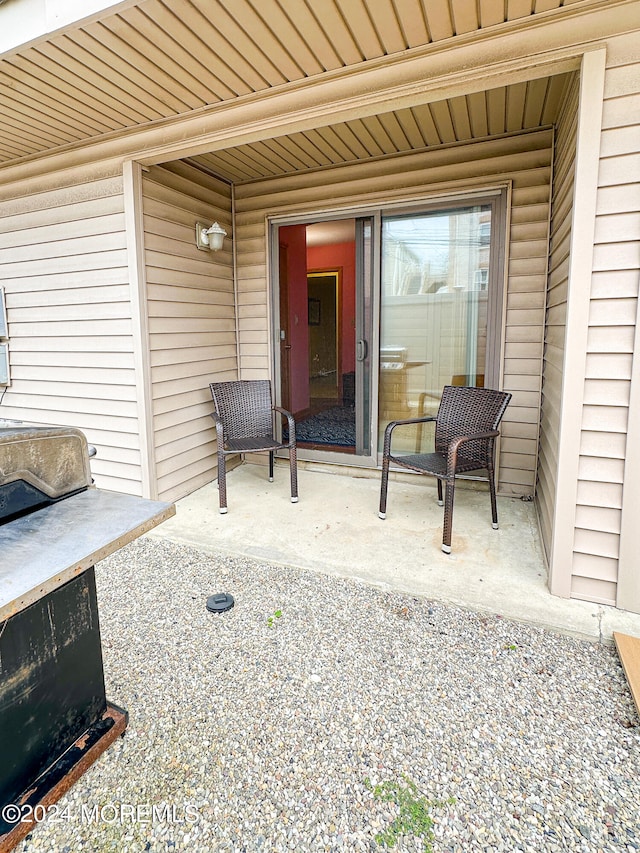 view of exterior entry featuring a patio area