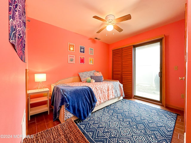 bedroom featuring ceiling fan, dark hardwood / wood-style flooring, and access to outside