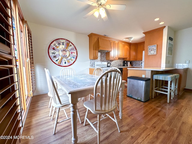 dining room featuring light hardwood / wood-style flooring and ceiling fan