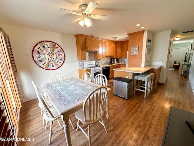 dining area featuring ceiling fan and light hardwood / wood-style flooring