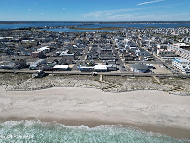 aerial view featuring a view of the beach and a water view