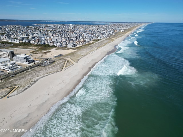 birds eye view of property featuring a water view and a view of the beach