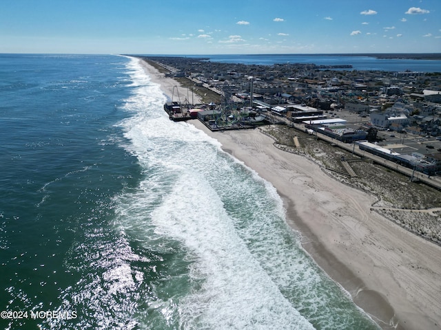 bird's eye view featuring a view of the beach and a water view