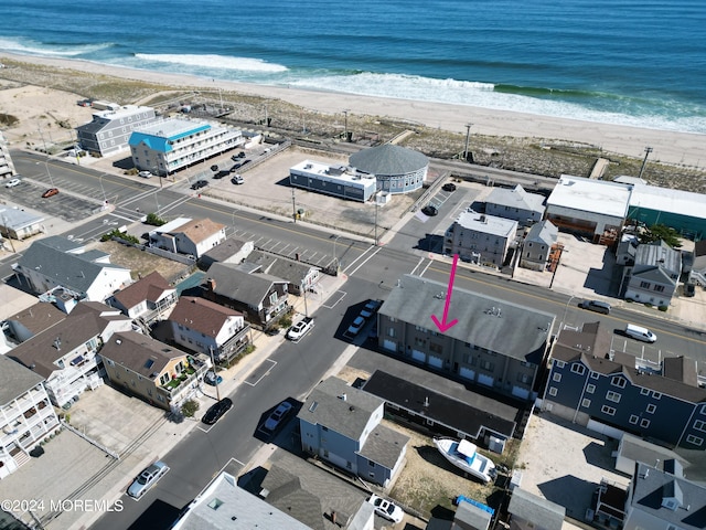 birds eye view of property featuring a view of the beach and a water view