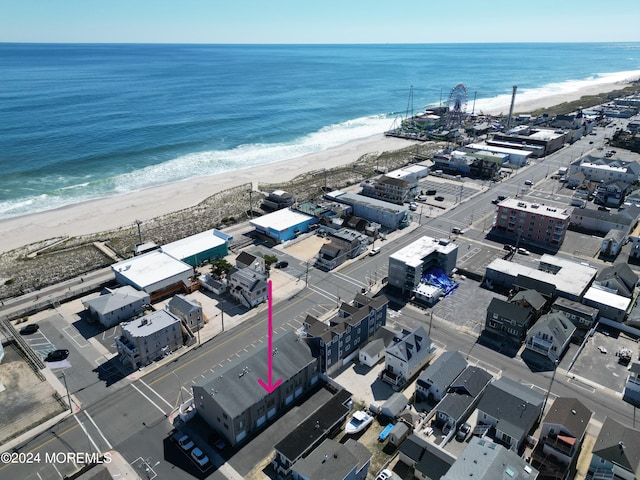 drone / aerial view featuring a view of the beach and a water view