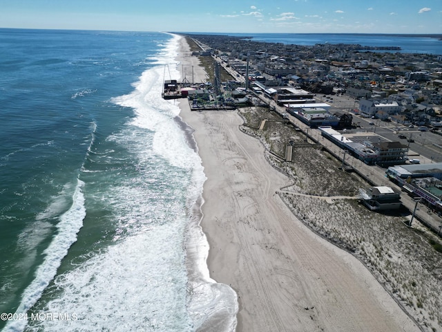 bird's eye view featuring a view of the beach and a water view