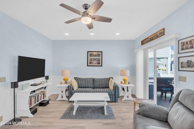 living room featuring light hardwood / wood-style floors and ceiling fan