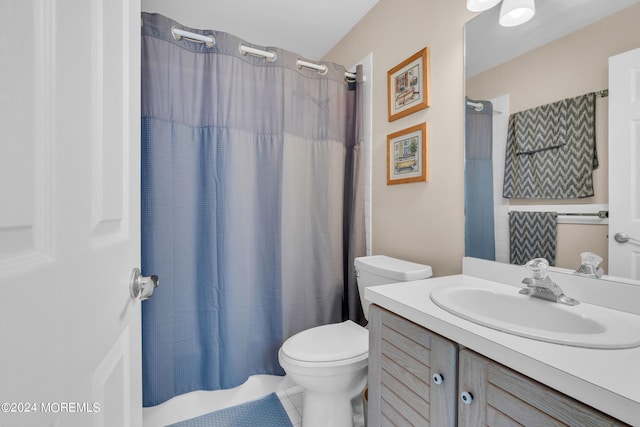 full bathroom with tile patterned flooring, shower / bathtub combination with curtain, vanity, and toilet