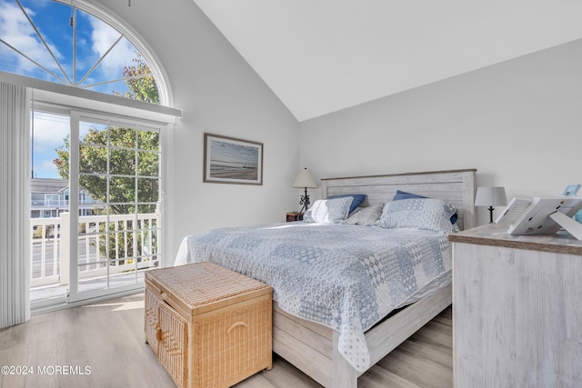 bedroom featuring access to exterior, high vaulted ceiling, and light wood-type flooring