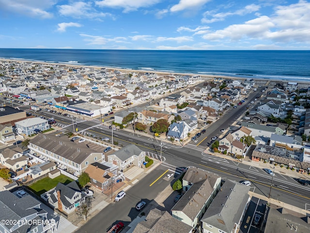 aerial view with a water view and a beach view