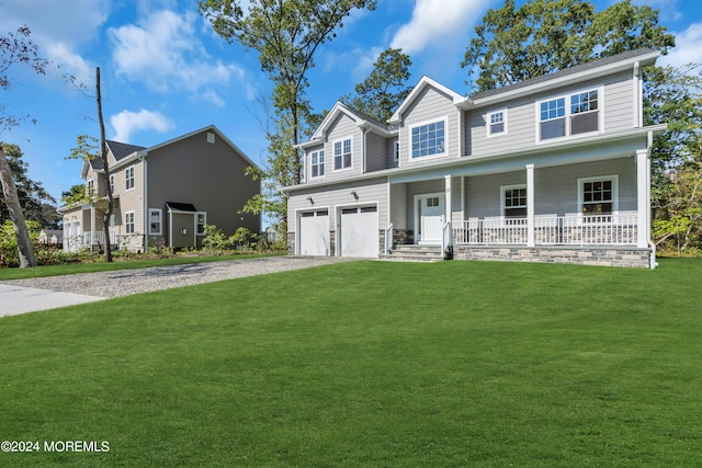 view of front of property with a front yard, covered porch, an attached garage, and gravel driveway