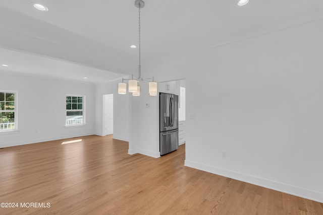 interior space with light wood-type flooring, baseboards, and recessed lighting