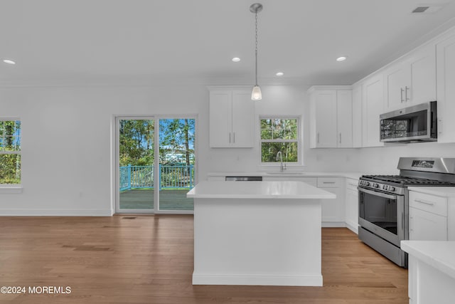 kitchen featuring appliances with stainless steel finishes, light countertops, and white cabinetry