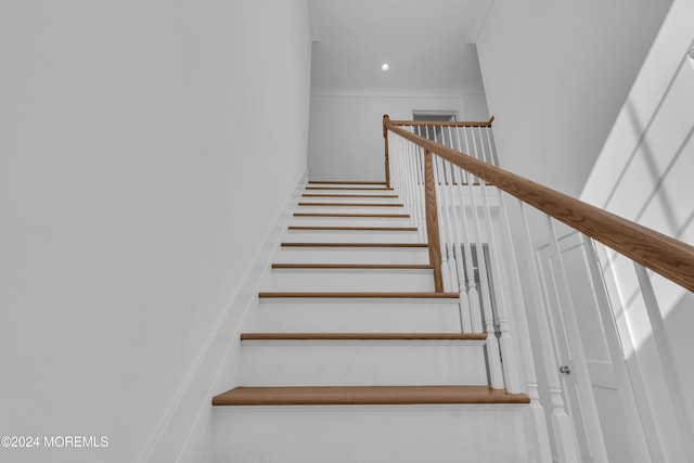 stairway featuring ornamental molding and recessed lighting