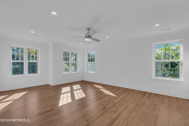 empty room with baseboards, ceiling fan, wood finished floors, and recessed lighting