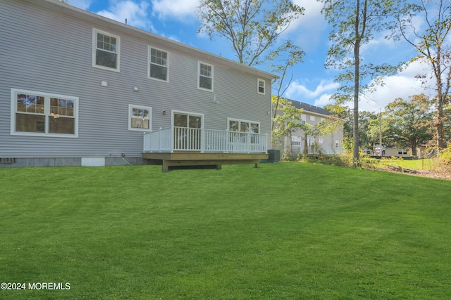 back of house featuring a deck, a yard, and cooling unit