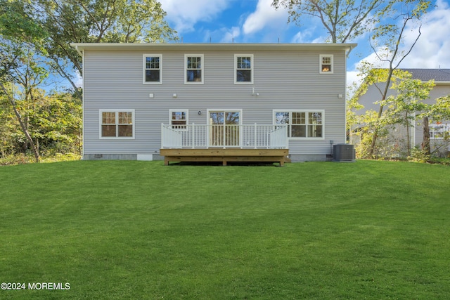 back of property with crawl space, a deck, and a lawn