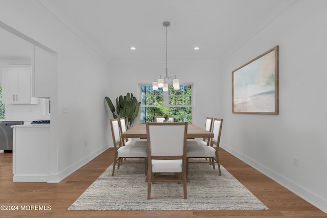 dining room with baseboards, light wood finished floors, recessed lighting, and an inviting chandelier