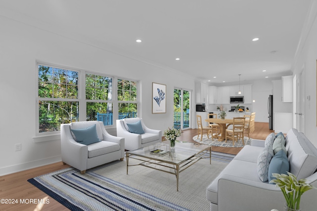 living room with light wood-style floors, recessed lighting, and baseboards