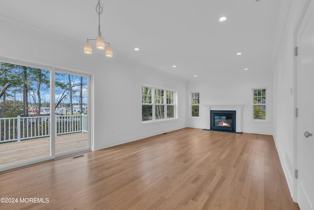 unfurnished living room with a fireplace with flush hearth, recessed lighting, visible vents, and light wood-style flooring