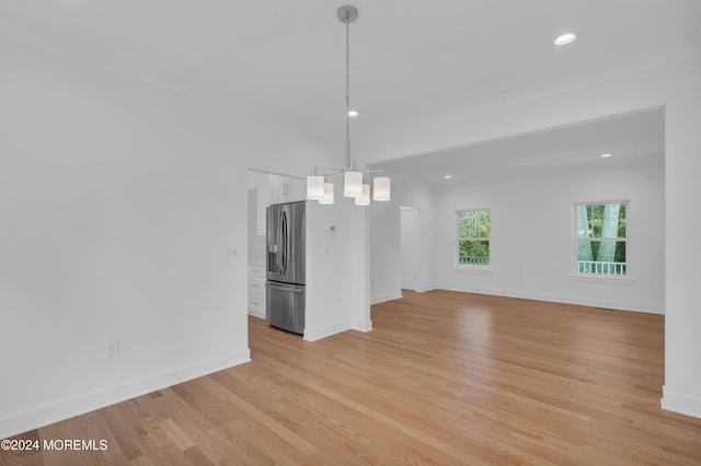 unfurnished dining area with recessed lighting, baseboards, and light wood finished floors