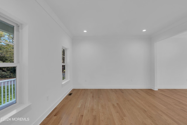 spare room with recessed lighting, visible vents, baseboards, light wood-type flooring, and crown molding