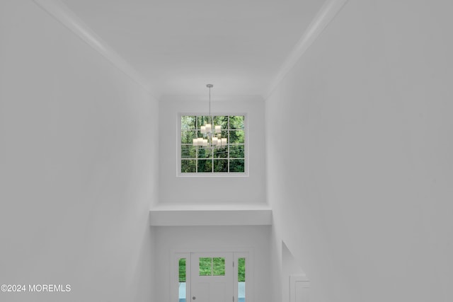 interior details featuring crown molding and a notable chandelier