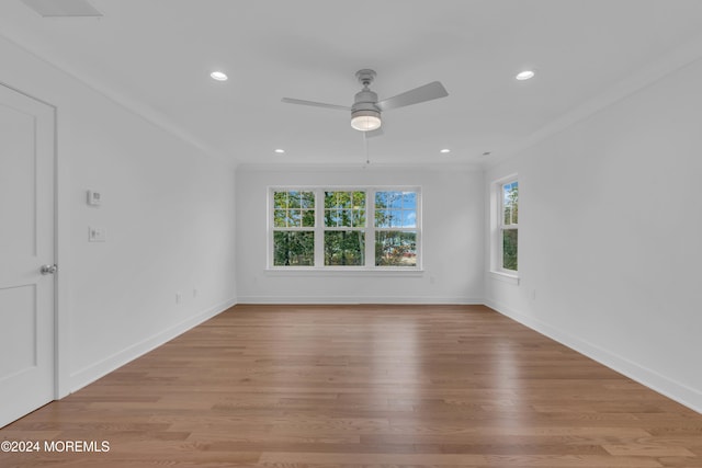 unfurnished room featuring light wood-style floors, baseboards, ornamental molding, and recessed lighting