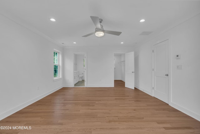 unfurnished bedroom featuring light wood-style floors, a walk in closet, and recessed lighting