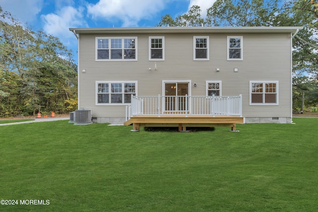 rear view of house with crawl space, cooling unit, a wooden deck, and a lawn