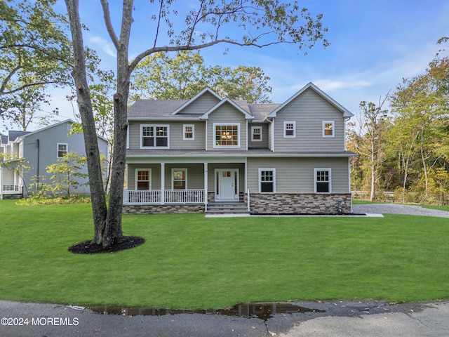 view of front of house featuring covered porch and a front yard