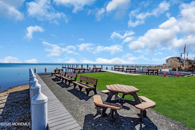 exterior space featuring a water view and a lawn