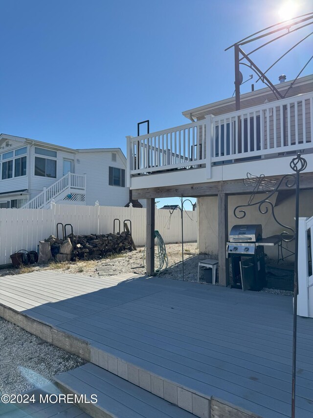 wooden deck featuring area for grilling