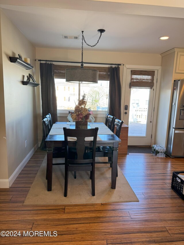 dining area featuring dark hardwood / wood-style flooring and a healthy amount of sunlight