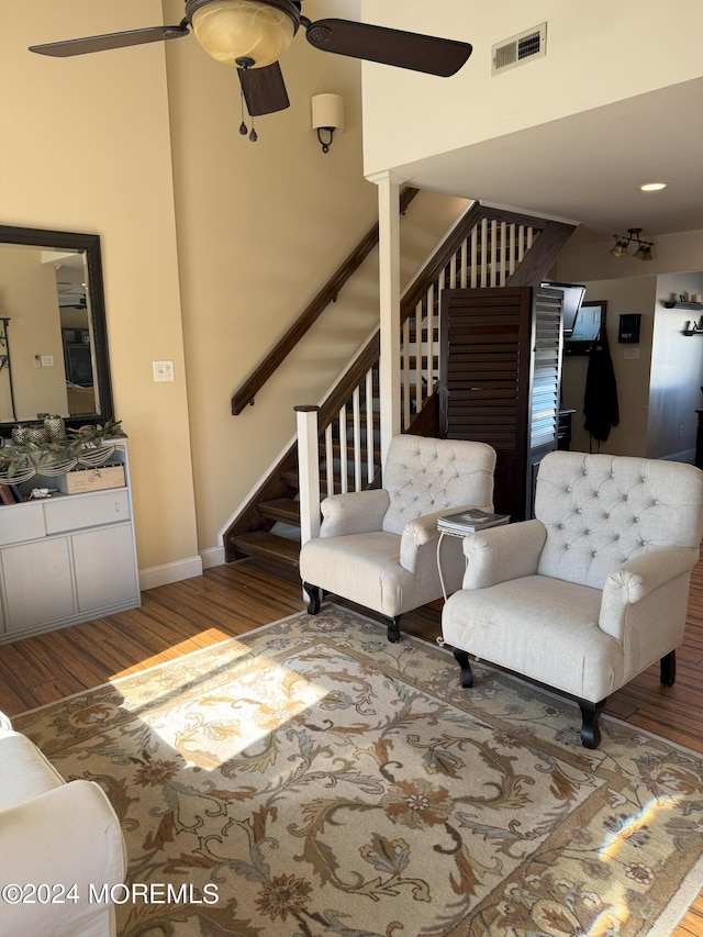 living room with hardwood / wood-style floors and ceiling fan