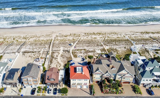aerial view with a residential view, a view of the beach, and a water view
