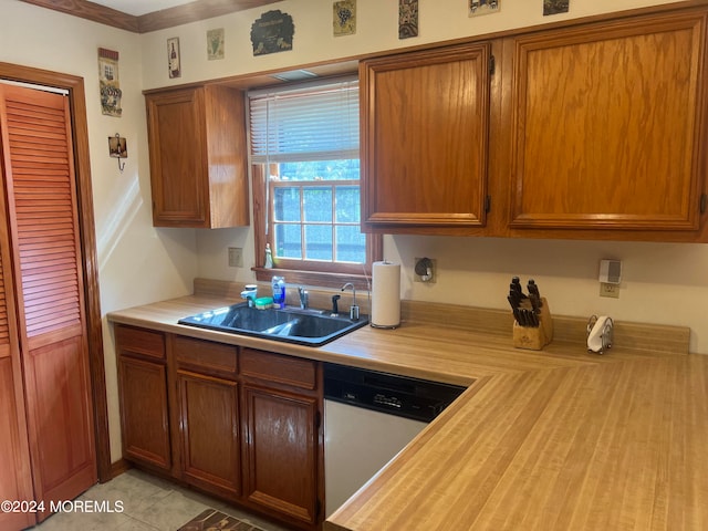 kitchen with sink, light tile patterned floors, and dishwasher