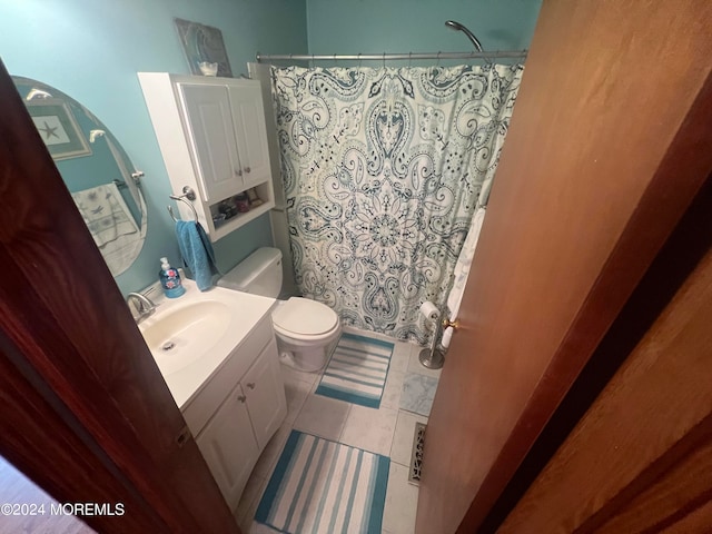 bathroom with vanity, tile patterned flooring, toilet, and curtained shower