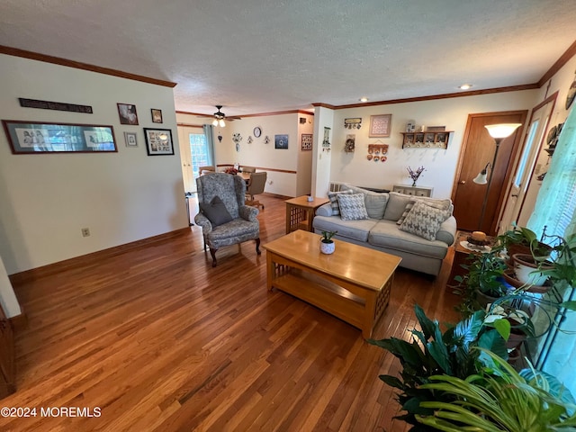 living room with crown molding, ceiling fan, dark hardwood / wood-style floors, and a textured ceiling