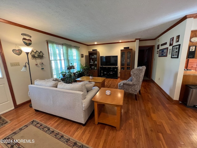 living room with ornamental molding, hardwood / wood-style floors, and a textured ceiling