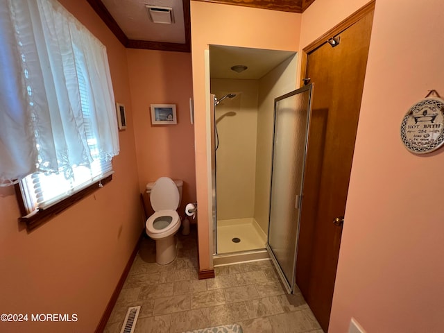 bathroom with crown molding, walk in shower, and toilet