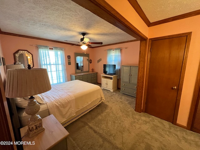 bedroom featuring ceiling fan, a textured ceiling, a closet, light colored carpet, and crown molding